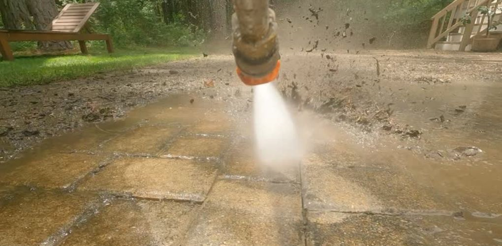 using power washer to clean patio